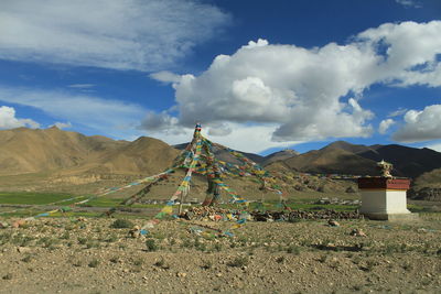 Built structure on field against sky