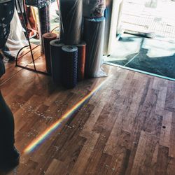 Low section of man standing on hardwood floor