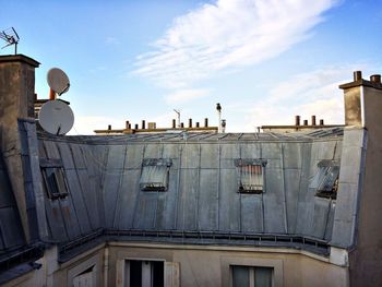 Satellite dish on building against sky