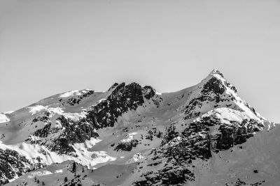 Scenic view of snowcapped mountains against clear sky