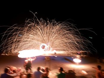 People watching firework display at night