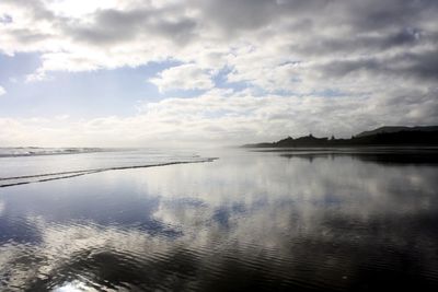 Scenic view of sea against cloudy sky