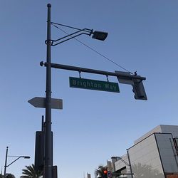 Low angle view of road sign against clear sky