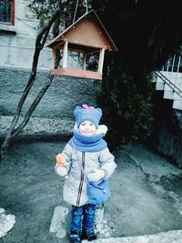 Full length of cute girl standing in snow