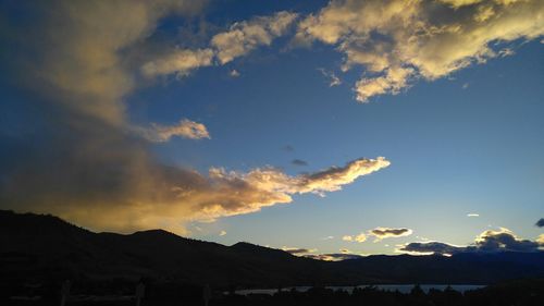 Scenic view of silhouette mountains against sky at sunset