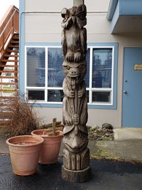 Statue of potted plants outside house