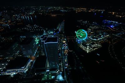 High angle view of city lit up at night