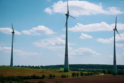 Windmill on field against sky