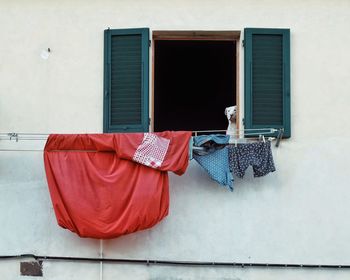 Clothes drying on clothesline against building