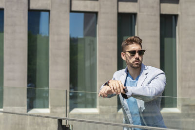 Young man looking through glass window