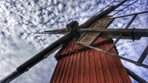 Low angle view of traditional windmill against sky