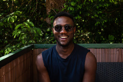Portrait of smiling young man wearing sunglasses