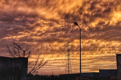 Low angle view of silhouette street light against sky