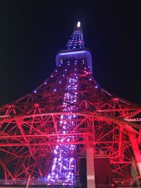 Low angle view of illuminated tower at night