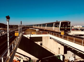 Train on bridge against clear sky