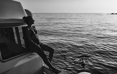 Boat sailing in sea against sky