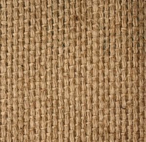 Texture of brown burlap, rough fabric with fibers for bags, macro