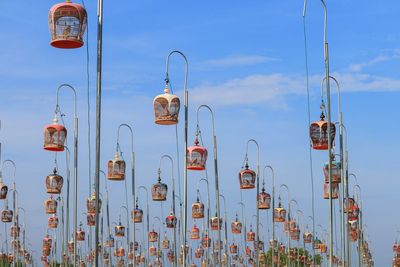 Low angle view of street lights against blue sky