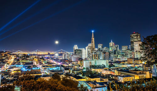 High angle view of illuminated buildings in city at night