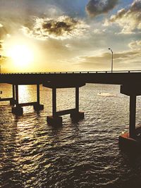 Pier on sea at sunset