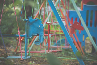 Close-up of empty rides in field