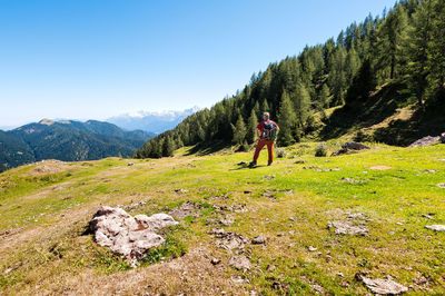 Full length of man climbing on mountain against sky