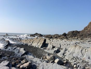 Scenic view of beach against clear sky