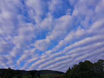 Scenic view of mountains against cloudy sky