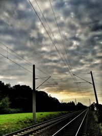 Railway tracks against sky during sunset