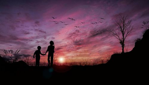 Silhouette people against sky during sunset