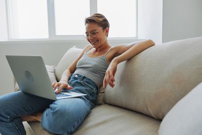 Young woman using laptop at home