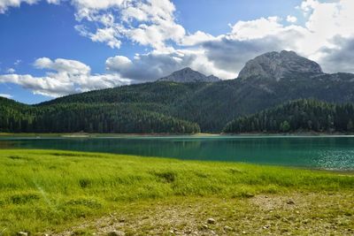 Scenic view of lake and mountains against sky