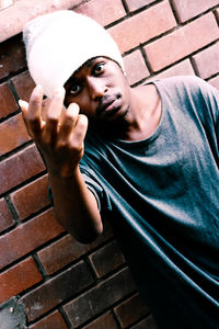 Portrait of young man against wall
