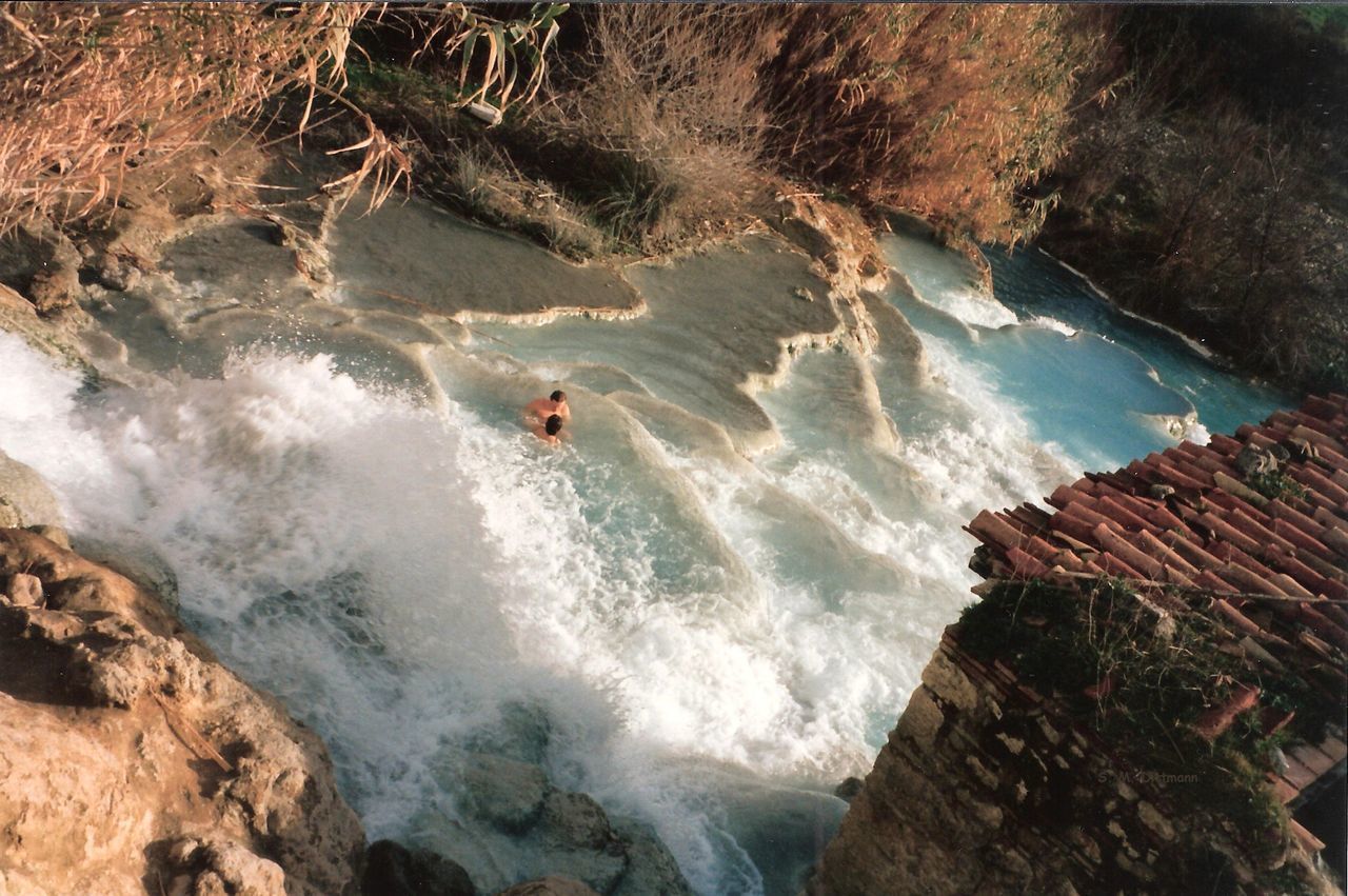 HIGH ANGLE VIEW OF MAN SURFING IN WATERFALL