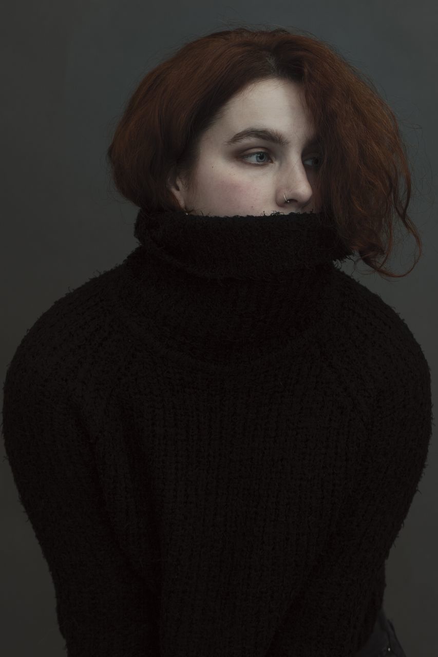 one person, portrait, looking at camera, indoors, sweater, young adult, clothing, studio shot, front view, lifestyles, young women, casual clothing, redhead, waist up, women, standing, real people, gray, turtleneck, hairstyle, beautiful woman, warm clothing