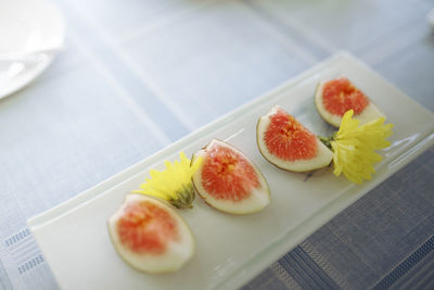 Sliced figs on white plate