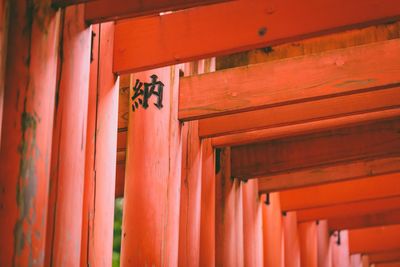 Red text on wooden door of building