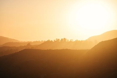 Scenic view of mountains against sky during sunset