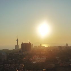 Buildings in city at sunset