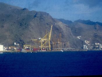 Scenic view of sea and mountains against sky