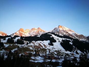 Scenic view of snowcapped mountains against clear sky