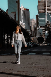 Portrait of young woman walking on street