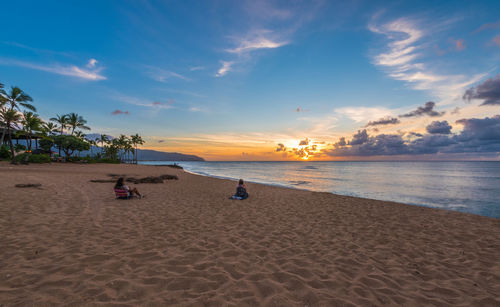 Scenic view of beach against sky during sunset