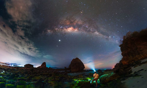 Scenic view of landscape against sky at night