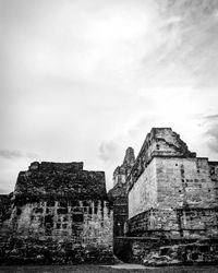 Low angle view of old building against cloudy sky