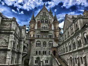 Low angle view of building against cloudy sky