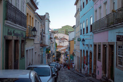 Cars on street amidst buildings in city