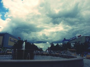 Buildings against cloudy sky