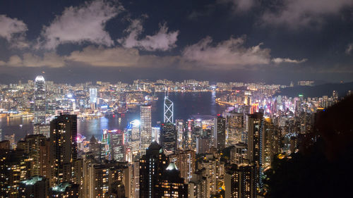 Illuminated cityscape against sky at night