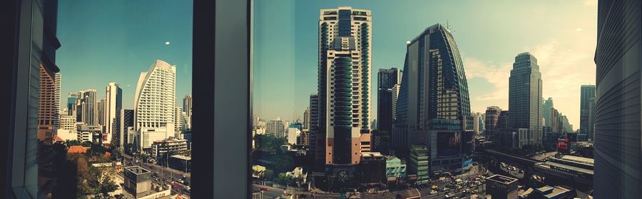 Panoramic view of modern buildings in city against sky